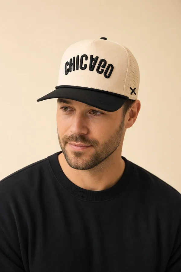 Man in a tan and black Chicago cap