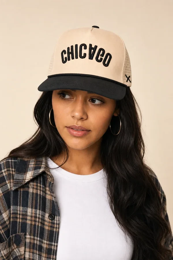 Woman wearing a cream and black Chicago cap