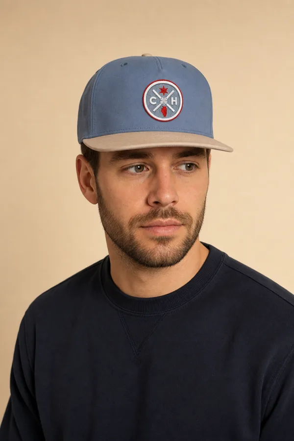 Man in a slate blue patch cap